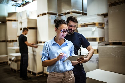 woman checking list of cargo